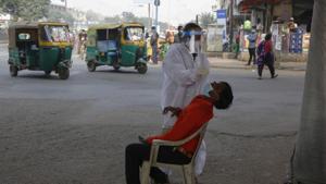 A health worker takes a nasal swab sample of a man to test for Covid-19 in Ahmedabad, India.(AP) A health worker takes a nasal swab sample of a man to test for Covid-19 in Ahmedabad, India.(AP)