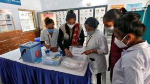Healthcare workers prepare a vaccination room inside a classroom of a school, which was converted into a temporary Covid-19 vaccination centre in Ahmedabad, on January 4.(Reuters Photo) Healthcare workers prepare a vaccination room inside a classroom of a school, which was converted into a temporary Covid-19 vaccination centre in Ahmedabad, on January 4.(Reuters Photo)