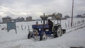A snow-clearing machine ploughs through a road on the outskirts of Srinagar on Wednesday as Kashmir remained cut off from the rest of the world for the fourth consecutive day due to heavy snowfall .(AP) A snow-clearing machine ploughs through a road on the outskirts of Srinagar on Wednesday as Kashmir remained cut off from the rest of the world for the fourth consecutive day due to heavy snowfall .(AP)