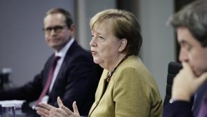 Germany's Chancellor Angela Merkel joins Markus Soeder (CSU), right, Prime Minister of Bavaria and CSU Chairman, and Michael Mueller (SPD), Governing Mayor of Berlin in a press conference following the consultations between the federal and state governments on further COVID measures, in Berlin, Tuesday, Jan. 5, 2021. (Michael Kappeler/pool photo via AP) Germany's Chancellor Angela Merkel joins Markus Soeder (CSU), right, Prime Minister of Bavaria and CSU Chairman, and Michael Mueller (SPD), Governing Mayor of Berlin in a press conference following the consultations between the federal and state governments on further COVID measures, in Berlin, Tuesday, Jan. 5, 2021. (Michael Kappeler/pool photo via AP)