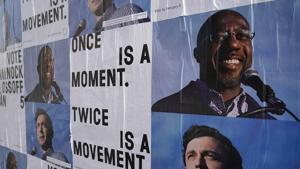 Campaign ads for Jon Ossoff and Raphael Warnock are seen on a wall near the John Lewis mural the day after the US Senate runoff elections in Atlanta, Georgia.(REUTERS) Campaign ads for Jon Ossoff and Raphael Warnock are seen on a wall near the John Lewis mural the day after the US Senate runoff elections in Atlanta, Georgia.(REUTERS)