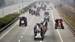 Farmers atop tractors during a rally in protest against new farm laws, in Dasna on January 7. Thousands of farmers protesting on Delhi’s borders demanding repeal of three contentious farm laws carries out a tractor march on January 7, converging on the eastern and western peripheral expressways that form a ring around Delhi. (Sakib Ali / HT Photo) Farmers atop tractors during a rally in protest against new farm laws, in Dasna on January 7. Thousands of farmers protesting on Delhi’s borders demanding repeal of three contentious farm laws carries out a tractor march on January 7, converging on the eastern and western peripheral expressways that form a ring around Delhi. (Sakib Ali / HT Photo)