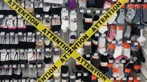 Tape is shown covering non-essential products that can't be sold at a pharmacy in Montreal, Quebec, Canada.(AP) Tape is shown covering non-essential products that can't be sold at a pharmacy in Montreal, Quebec, Canada.(AP)