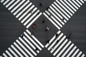 A thin crowd walks across pedestrian crossings in the Ginza shopping area of Tokyo, Japan on January 8. Japanese Prime Minister Yoshihide Suga has declared a state of emergency in Tokyo and three adjoining prefectures, after Covid-19 infections and the number of people in serious condition reached record levels. The measure has been imposed from January 8 to February 7. (Eugene Hoshiko / AP) A thin crowd walks across pedestrian crossings in the Ginza shopping area of Tokyo, Japan on January 8. Japanese Prime Minister Yoshihide Suga has declared a state of emergency in Tokyo and three adjoining prefectures, after Covid-19 infections and the number of people in serious condition reached record levels. The measure has been imposed from January 8 to February 7. (Eugene Hoshiko / AP)