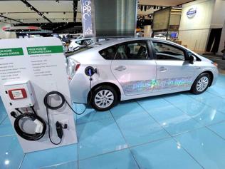Toyota-Prius-plug-in-hybrid-car-with-model-of-a-home-charging-station-on-display-during-the-second-press-preview-day-at-the-2012-North-American-International-Auto-Show-in-Detroit-AFP-Photo