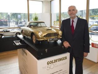 Michael-G-Wilson-Producer-EON-Productions-poses-with-the-unique-gold-Aston-Martin-DB5-Photo-AFP Michael-G-Wilson-Producer-EON-Productions-poses-with-the-unique-gold-Aston-Martin-DB5-Photo-AFP