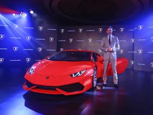 Sebastien-Henry-Head-Automobili-Lamborghini-South-East-Asia-and-Pacific-poses-with-the-Huracan-LP-610-4-during-its-launch-ceremony-in-Mumbai-September-22-2014-The-price-of-the-Huracan-will-start-from-Rs-34-300-000-rupees-563-983-for-the-base-model-according-to-the-press-release-Photo-Reuters