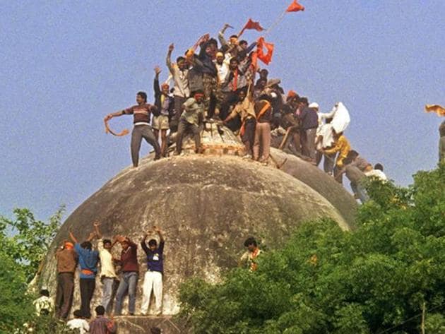 File photo of kar sevaks atop the Babri masjid shortly before it was demolished on December 6, 1992.(HT PHOTO)
