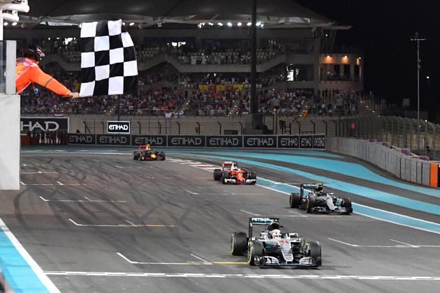 Mercedes AMG Petronas F1 Team's British driver Lewis Hamilton crosses the finish line at the end of the Abu Dhabi Formula One Grand Prix at the Yas Marina circuit on November 27, 2016. (AFP)