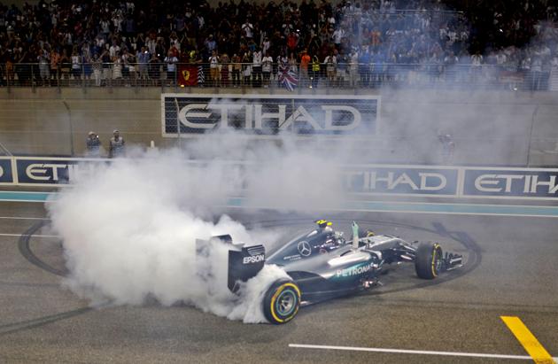 Mercedes AMG Petronas F1 Team's German driver Nico Rosberg celebrates at the end of the Abu Dhabi Formula One Grand Prix at the Yas Marina circuit on November 27, 2016. (AFP)