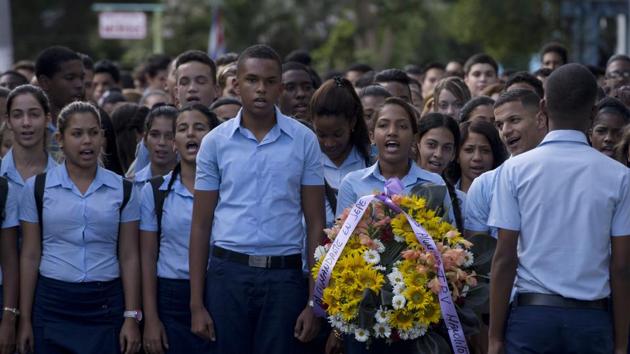 Students march, one carrying a wreath, to a memorial honoring the late Fidel Castro, in the Ciudad Escolar Libertad neighborhood in Havana, Cuba, Monday, Nov. 28, 2016. Cubans on Monday began bidding farewell to Castro, the man who ruled the island for nearly half a century. Cuba's government has declared nine days of national mourning following Castro's death Friday night at age 90. (AP) Students march, one carrying a wreath, to a memorial honoring the late Fidel Castro, in the Ciudad Escolar Libertad neighborhood in Havana, Cuba, Monday, Nov. 28, 2016. Cubans on Monday began bidding farewell to Castro, the man who ruled the island for nearly half a century. Cuba's government has declared nine days of national mourning following Castro's death Friday night at age 90. (AP)