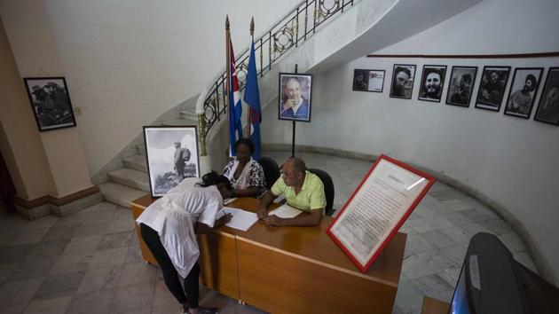 A woman signs a book of condolences, and a loyalty oath for the late Fidel Castro at the Journalists and Writers Union Federation building in Havana, Cuba, Monday, Nov. 28, 2016. Cubans on Monday began bidding farewell to Castro, the man who ruled the island for nearly half a century. (AP) A woman signs a book of condolences, and a loyalty oath for the late Fidel Castro at the Journalists and Writers Union Federation building in Havana, Cuba, Monday, Nov. 28, 2016. Cubans on Monday began bidding farewell to Castro, the man who ruled the island for nearly half a century. (AP)