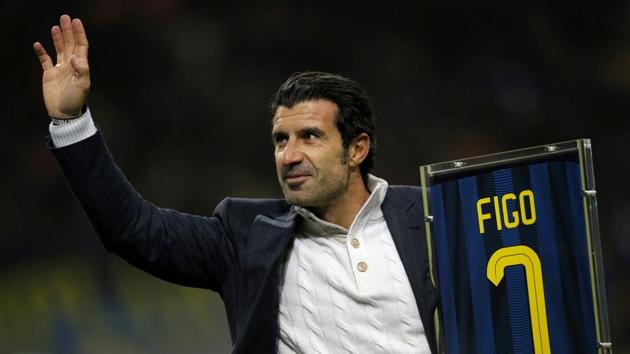 Former Inter Milan's player Luis Figo waves as he holds his jersey prior to the match. (AFP)