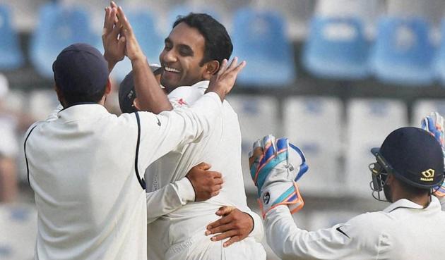 Jayant Yadav celebrates with India captain Virat Kohli and teammates after dismissing England batsman Jos Buttler on the fourth day of the third Test in Mohali on Tuesday.(PTI)