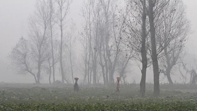 Kashmiri women walk surrounded by a dense fog on a cold morning on the outskirts Srinagar. The Kashmir region is experiencing cold and foggy conditions after the Himalayan mountains received snowfall in the past few days. (AP)