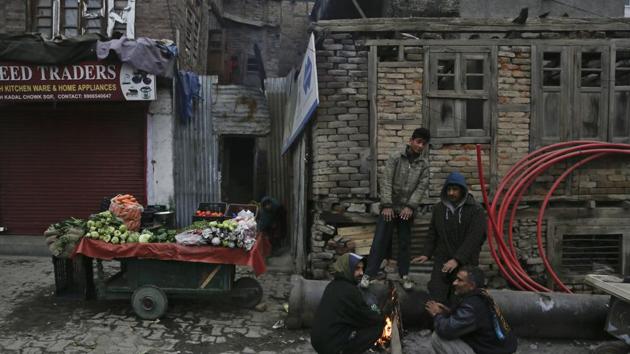 Kashmiri men warm their hands near a bonfire on a cold morning in Srinagar. The Kashmir region is experiencing cold and foggy conditions after the Himalayan mountains received snowfall in the past few days. (AP)