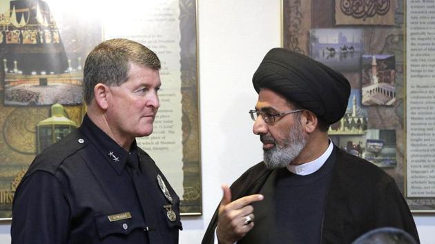Los Angeles Police Deputy Chief Michael Downing talks with Sayed Moustafa al-Qazwini, founding Imam of the Islamic Educational Center of Orange County at a news conference at the Islamic Center of Southern California in Los Angeles on Monday.(AP Photo)