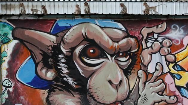 Monkeys sit on a graffiti wall during the Monkey Buffet Festival, near the Phra Prang Sam Yot temple in Lopburi province, north of Bangkok, Thailand November 27, 2016. REUTERS/Chaiwat Subprasom. (REUTERS)