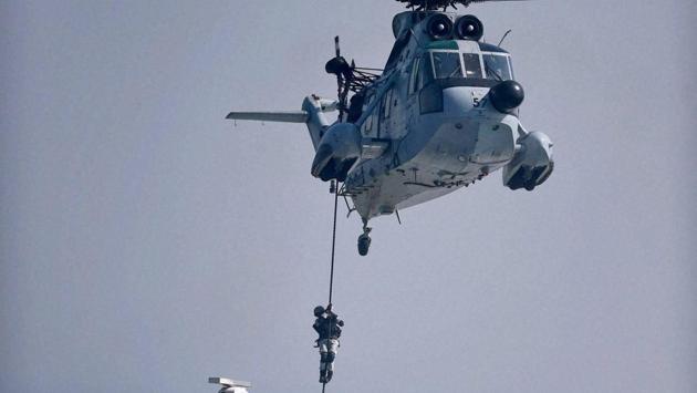 Navy personnel perform during 'Day at Sea' exercise conducted as part of the Navy Day celebrations in Mumbai on Monday. (PTI Photo) 