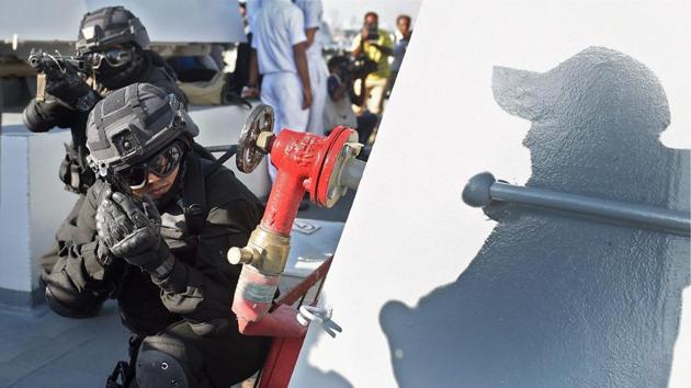 Naval commandos perform during 'Day at Sea' exercise conducted as part of the Navy Day celebrations in Mumbai on Monday. (PTI Photo) 