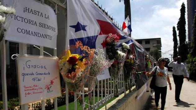 People walk past the fence of the Cuban embassy in Panama City where Fidel Castro's followers placed letters, flowers and banners on November 28, 2016. Cuban revolutionary icon Fidel Castro died last Friday in Havana, his brother, President Raul Castro, announced on national television. Castro's ashes will be buried in the historic southeastern city of Santiago on December 4 after a four-day procession through the country. (AFP) People walk past the fence of the Cuban embassy in Panama City where Fidel Castro's followers placed letters, flowers and banners on November 28, 2016. Cuban revolutionary icon Fidel Castro died last Friday in Havana, his brother, President Raul Castro, announced on national television. Castro's ashes will be buried in the historic southeastern city of Santiago on December 4 after a four-day procession through the country. (AFP)