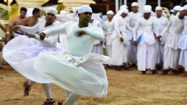 Legend has it that a king was plagued with a painful headache. No amount of medicine or magic helped. Then, wise men told him to seek solace in a land sanctified by Buddhist philosophy. That’s how he reached Sri Lanka. He arrived at a place called Navagamuwa. A grand altar was set up where the ritual was first performed. (AFP) Legend has it that a king was plagued with a painful headache. No amount of medicine or magic helped. Then, wise men told him to seek solace in a land sanctified by Buddhist philosophy. That’s how he reached Sri Lanka. He arrived at a place called Navagamuwa. A grand altar was set up where the ritual was first performed. (AFP)