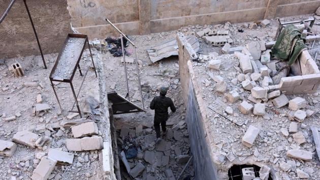 A member of Syrian pro-government forces inspects an area on November 27, 2016 in the Masaken Hanano district in eastern Aleppo, a day after they resized it from rebel fighters. Syria regime forces seized two new rebel-held districts in Aleppo a day after they retook the largest opposition-controlled neighbourhood in the second city, a monitor said. The capture of Masaken Hanano -- which had been the biggest rebel-held district of Aleppo -- was a major breakthrough in a 13-day regime offensive to retake the entire city. / AFP PHOTO / GEORGE OURFALIAN (AFP) A member of Syrian pro-government forces inspects an area on November 27, 2016 in the Masaken Hanano district in eastern Aleppo, a day after they resized it from rebel fighters. Syria regime forces seized two new rebel-held districts in Aleppo a day after they retook the largest opposition-controlled neighbourhood in the second city, a monitor said. The capture of Masaken Hanano -- which had been the biggest rebel-held district of Aleppo -- was a major breakthrough in a 13-day regime offensive to retake the entire city. / AFP PHOTO / GEORGE OURFALIAN (AFP)