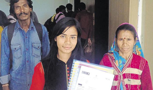 Asha Gond with her parents at the passport office in Bhopal.(HT photo) Asha Gond with her parents at the passport office in Bhopal.(HT photo)