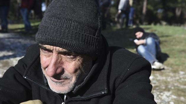 A Syrian refugee waits to be picked up by the police on the outskirts of the northern Greek city of Thessaloniki, on Wednesday. (AP) A Syrian refugee waits to be picked up by the police on the outskirts of the northern Greek city of Thessaloniki, on Wednesday. (AP)