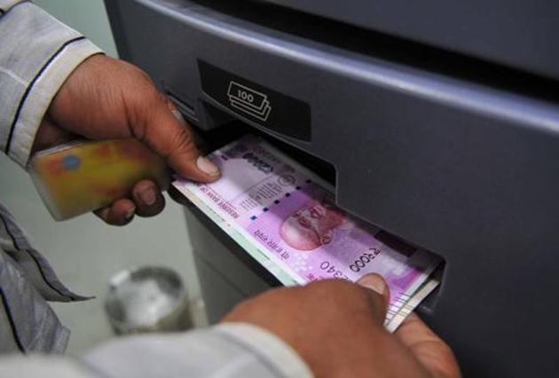 A man takes out Rs 2,000 banknotes from an ATM in November 2016. The government’s decision to replace 1,000 and 500 rupee banknotes with new 2,000 rupee notes has upset the country’s cash flow.(Shankar Mourya/HT File Photo)
