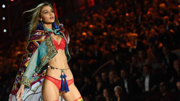 Gigi Hadid presents a creation with her trademark expression on her face. (AFP)