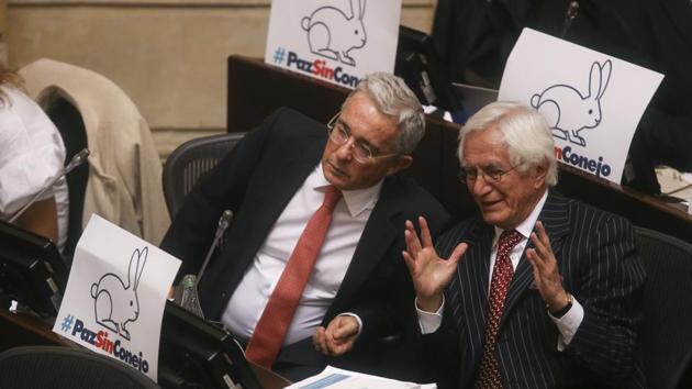 Former president and opposition Senator Alvaro Uribe, left, listens to Bogota's former mayor Jaime Castro during a Senate session in Bogota, Colombia . (AP File Photo) Former president and opposition Senator Alvaro Uribe, left, listens to Bogota's former mayor Jaime Castro during a Senate session in Bogota, Colombia . (AP File Photo)