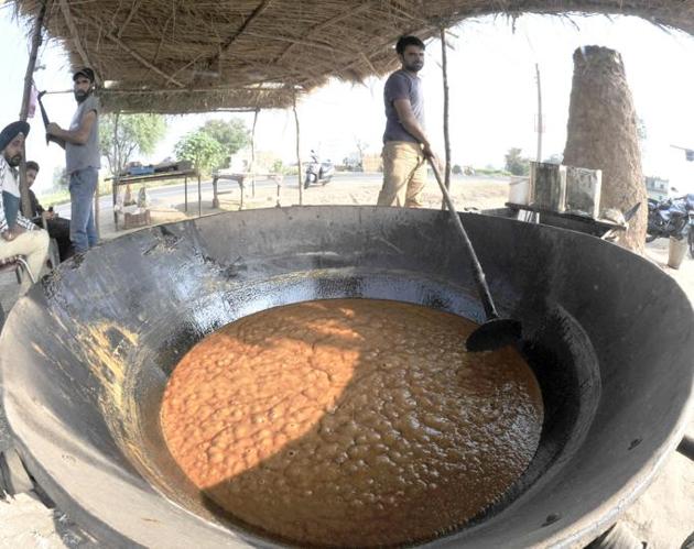 The cane juice is heated to reduce it into a concentrate. (Ravi Kumar/HT)