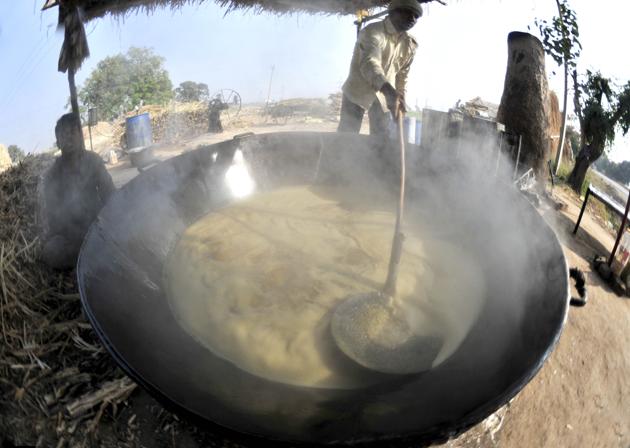 The cane juice is heated to reduce it into a concentrate. (Ravi Kumar/HT)