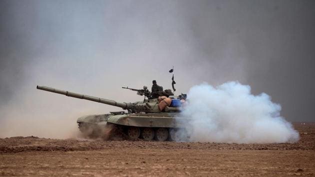 Iraqi Shia fighters from the Hashed al-Shaabi (Popular Mobilisation) paramilitaries manoeuver a T-72 tank as they advance near the village of Tal Abtah, south of Tal Afar, on November 30, 2016(AFP Photo)