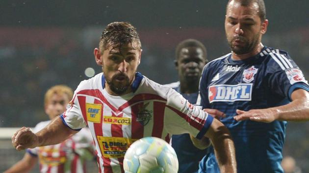 Atletico de Kolkata forward Juan Belencoso (Left) vies for the ball with FC Pune City defender Eduardo Ferreira during their ISL match in Kolkata on Friday. (AFP) Atletico de Kolkata forward Juan Belencoso (Left) vies for the ball with FC Pune City defender Eduardo Ferreira during their ISL match in Kolkata on Friday. (AFP)