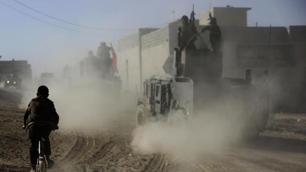 An Iraqi boy rides his bicycle as he follows the special forces soldier humvees who are on their way to the front line to battle against Islamic State militants, in Mosul, Iraq. (AP File Photo) An Iraqi boy rides his bicycle as he follows the special forces soldier humvees who are on their way to the front line to battle against Islamic State militants, in Mosul, Iraq. (AP File Photo)