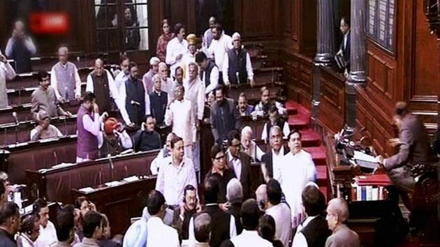 Opposition members protest in the well of the Rajya Sabha in New Delhi. (PTI Photo) Opposition members protest in the well of the Rajya Sabha in New Delhi. (PTI Photo)
