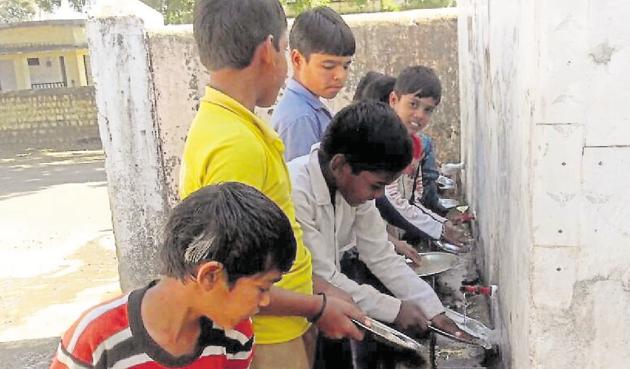 Students at the government primary school at Chachoda in Guna washing utensils after mid-day meal. Students at the government primary school at Chachoda in Guna washing utensils after mid-day meal.