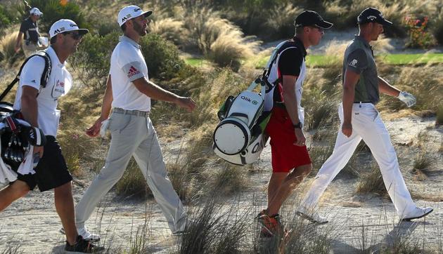 Henrik Stenson (R) of Sweden walks with tee-off partner Dustin Johnson (second from left) of the United States who is in joint lead with Hideki Matsuyama  after the second round of the Hero World Challenge at Albany, the Bahamas. Tiger Woods hit a bogey-free round on Friday, and is six shots behind the co-leaders. (AFP)