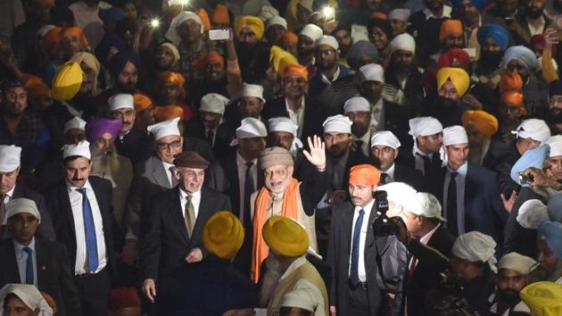 Prime Minister Narendra Modi waves as he walks with Afghanistan President Ashraf Ghani at the Golden Temple in Amritsar on Saturday. On Sunday, they will be at the Heart of Asia conference. (Gurpreet Singh/HT)