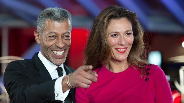 French television journalist Rachid M'Barki with his wife Marianne Soubret at the opening event. (AFP)