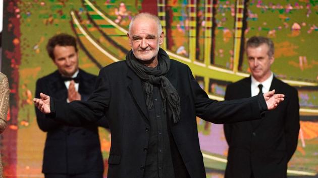 Hungarian film director Bela Tarr, also the jury president at the festival, made a dramatic entry for the opening ceremony. (AFP)