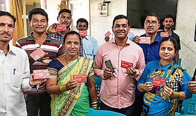 Chinmay Gavankar (in pink) shows the mVisa cards with fisherfolk. (HT PHOTO) Chinmay Gavankar (in pink) shows the mVisa cards with fisherfolk. (HT PHOTO)