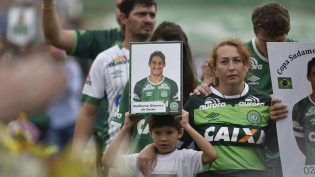 Relatives of the members of the Chapecoense Real football club, who were killed in an air crash in Colombia, pay tribute to their loved ones at the stadium in Chapeco, Santa Catarina, Brazil, on Saturday. (AFP) Relatives of the members of the Chapecoense Real football club, who were killed in an air crash in Colombia, pay tribute to their loved ones at the stadium in Chapeco, Santa Catarina, Brazil, on Saturday. (AFP)