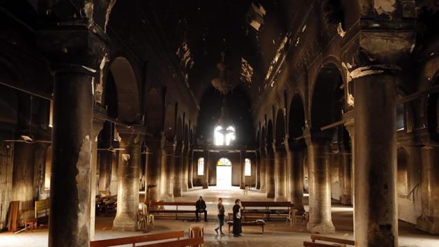 Iraqi Christian residents of Qaraqosh (also known as Hamdaniya), come to pray at the heavily damaged Church, some 30 km east of Mosul. (AFP Photo) Iraqi Christian residents of Qaraqosh (also known as Hamdaniya), come to pray at the heavily damaged Church, some 30 km east of Mosul. (AFP Photo)