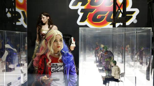 Women dressed in costumes from the film Suicide Squad look at figures of movie characters at Tokyo Comic Con. (REUTERS)
