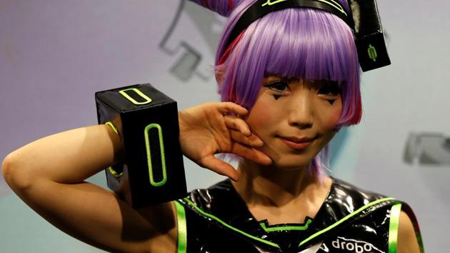A woman dressed in a costume poses for a photograph at Tokyo Comic Con at Makuhari Messe in Chiba. (REUTERS)