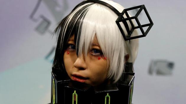 A woman dressed in a costume poses for a photograph at Tokyo Comic Con at Makuhari Messe. (REUTERS)
