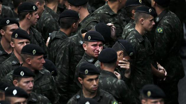 Brazilian soldiers react during a memorial ceremony with the coffins of the victims of the plane crash in Colombia, in the Arena Conda stadium in Chapeco, Brazil, December 3, 2016. (Ricardo Moraes /REUTERS) Brazilian soldiers react during a memorial ceremony with the coffins of the victims of the plane crash in Colombia, in the Arena Conda stadium in Chapeco, Brazil, December 3, 2016. (Ricardo Moraes /REUTERS)